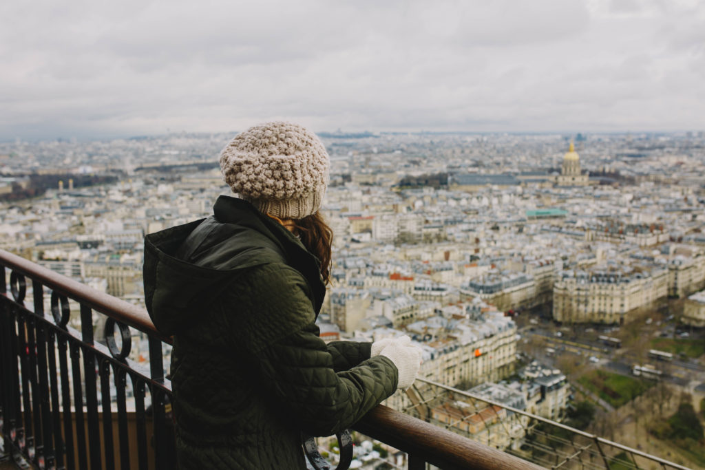 Girl looking down from Eiffel Tower in Paris