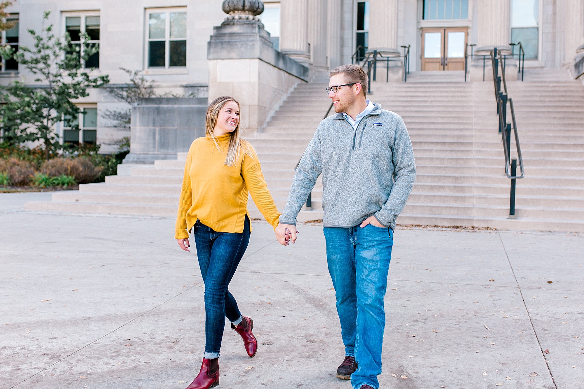 Engaged couple holding hands at Curtis Hall Iowa State