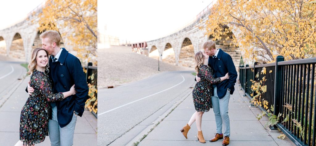 Engaged couple kissing in by Mill City Ruins Park