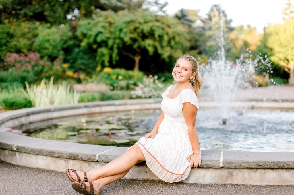 Senior girl sitting on fountain