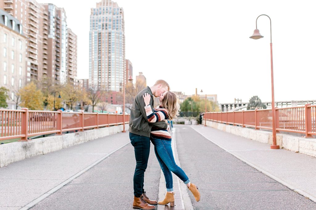 Couple kissing on Stone Arch Bridge