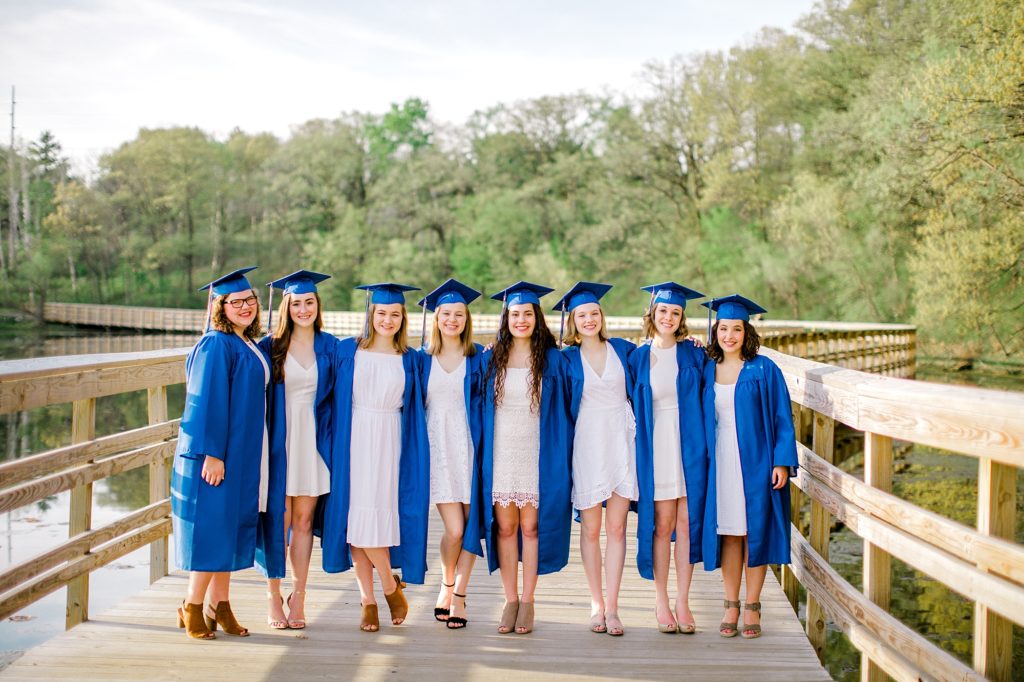 Group of girl graduates on bridge