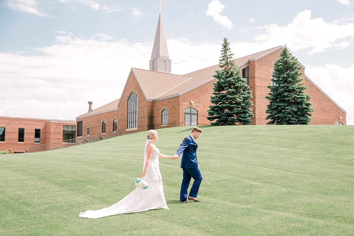 Bride and groom walking in front of church