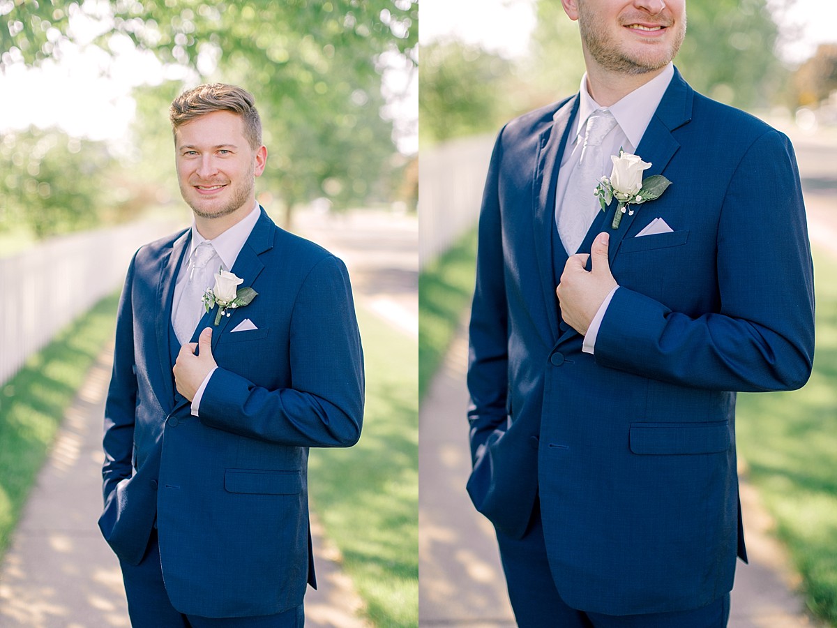 Groom wearing navy suit and boutinniere