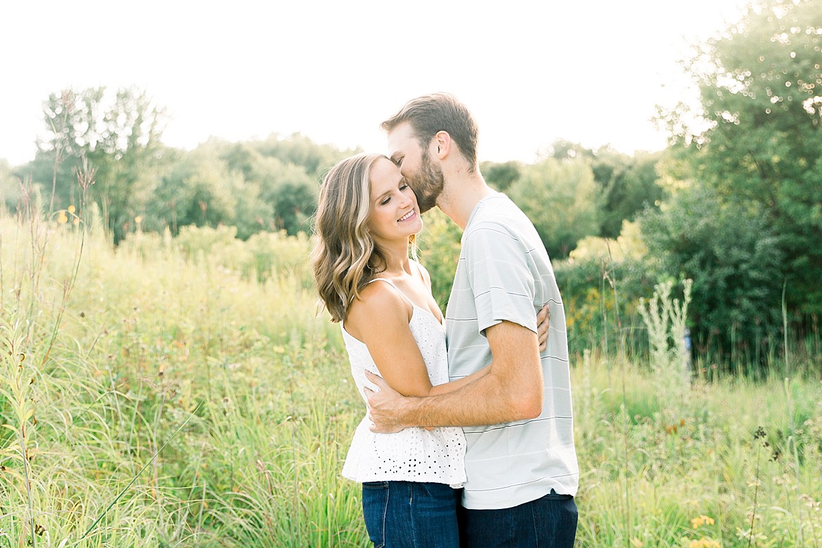 Couple kissing in field at Lebanon Hills