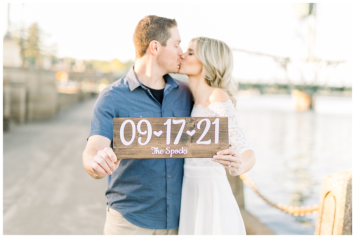 Couple holding wedding date sign