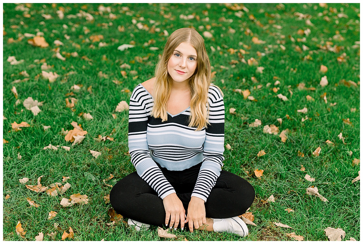Girl sitting in grass for senior photos