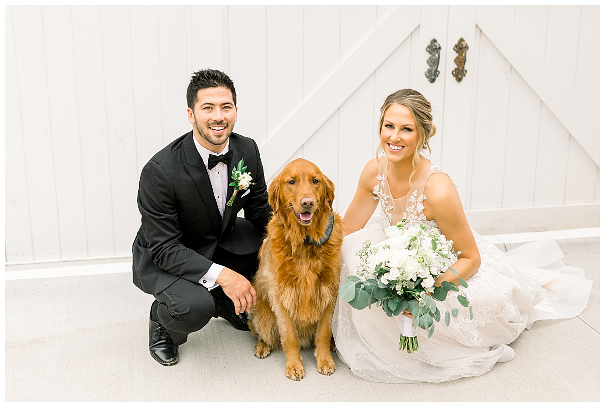 bride and groom with dog at wedding