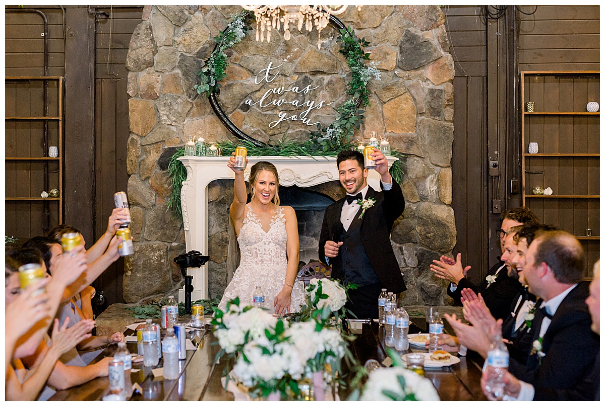 bride and groom cheers at reception