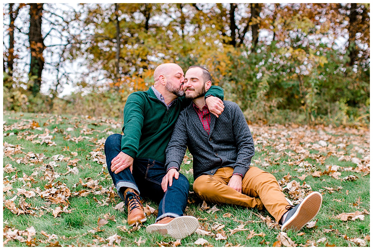 couple kissing for fall engagement