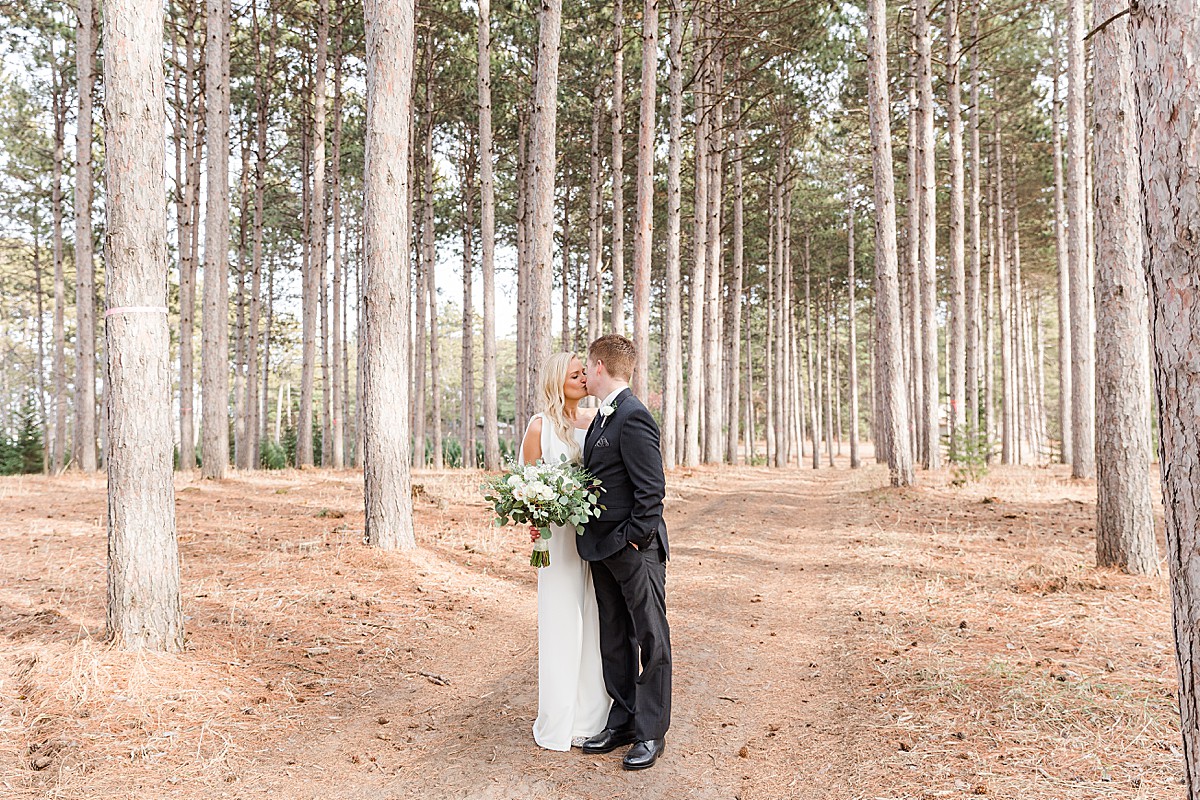 Winter wedding photo in tall pines