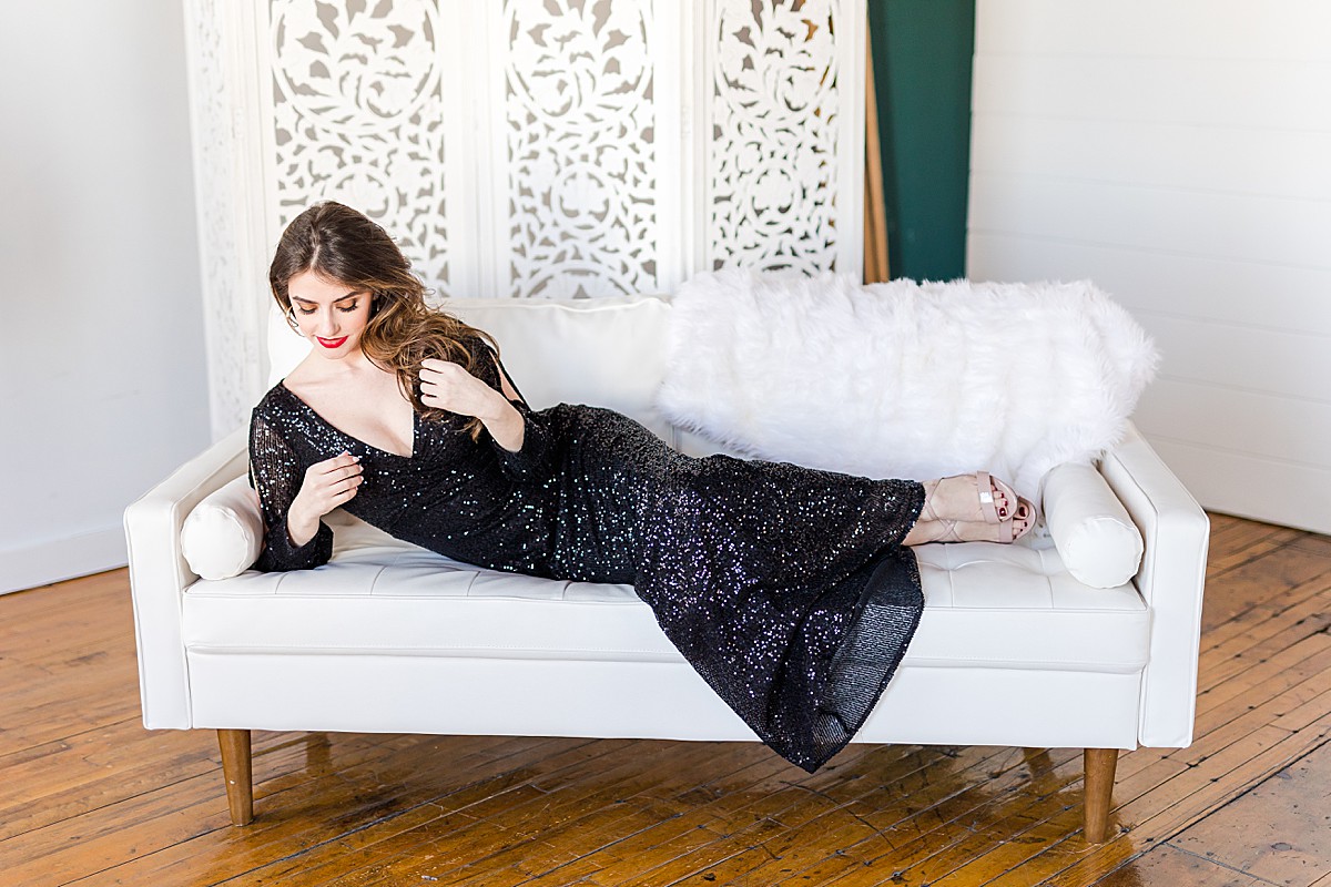 Woman in black sequin dress on couch