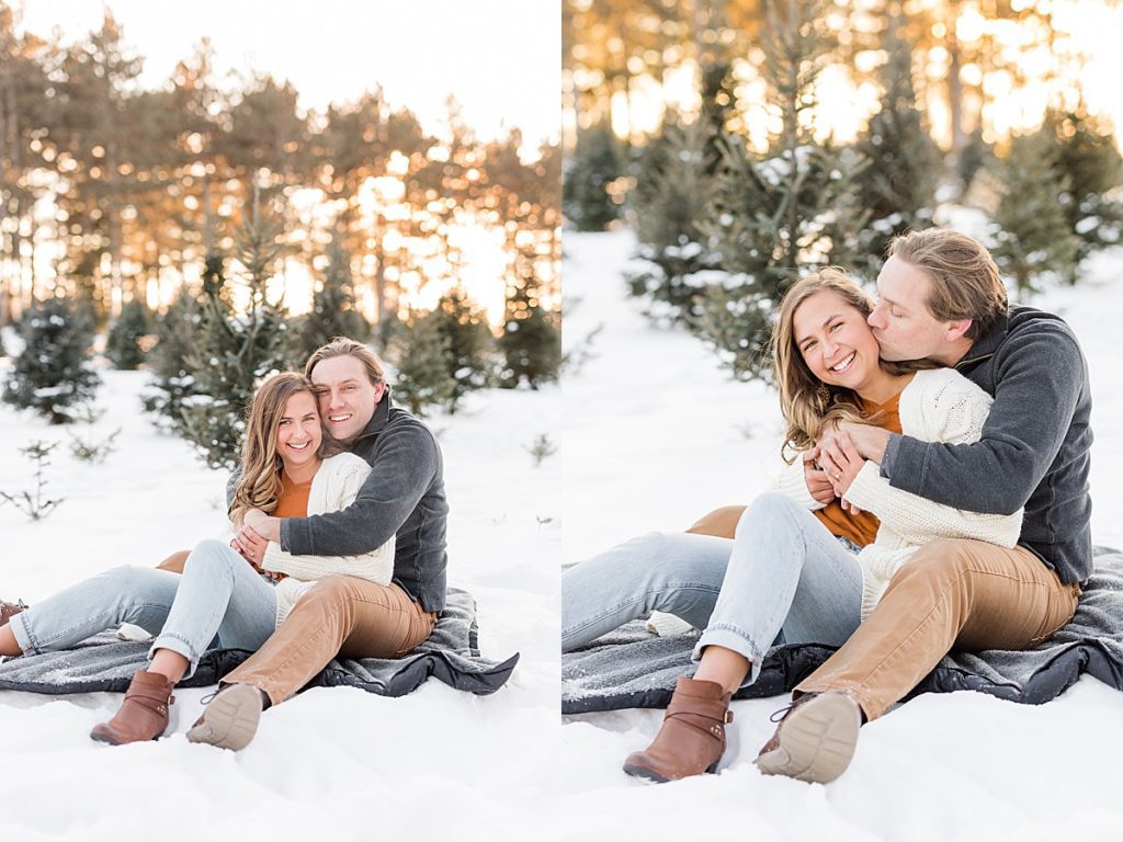 Couple sitting on blanket snuggling in snow