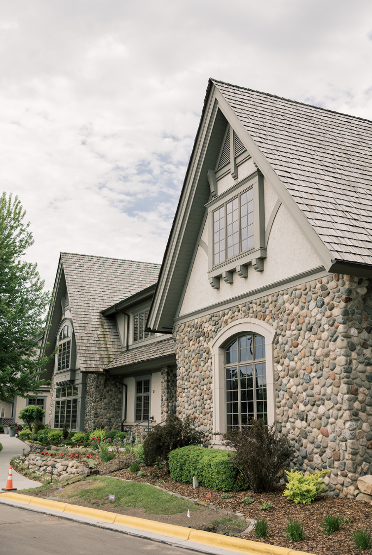 Stone exterior at Rush Creek Golf Club with the Tudor-style clubhouse