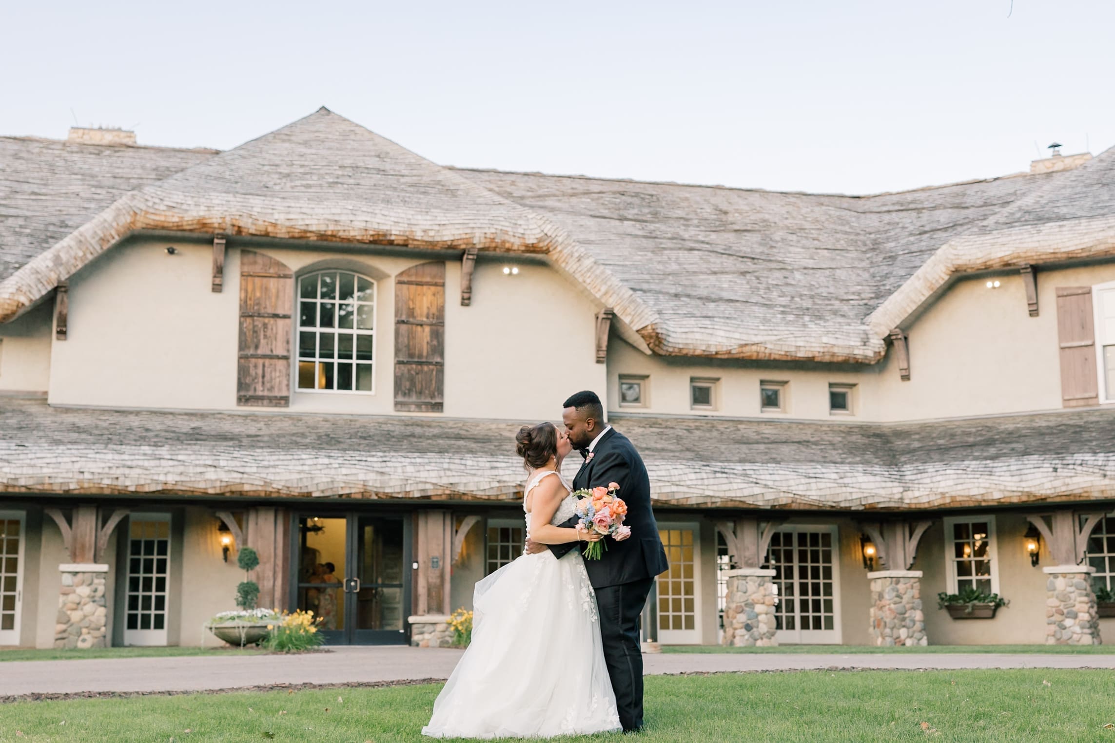 wide shot of a bride and groom kissing at the bavaria downs estate in MN
